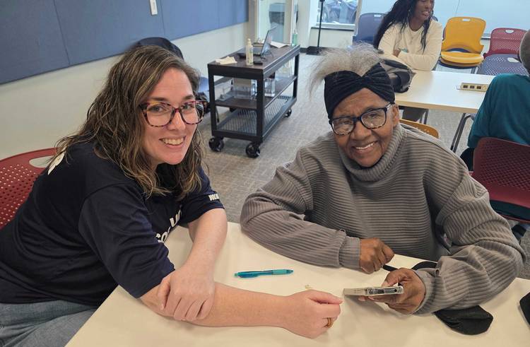 Spectrum technical support supervisor and volunteer Nicole Waldren, L, and Glenville resident Wilma Miles.